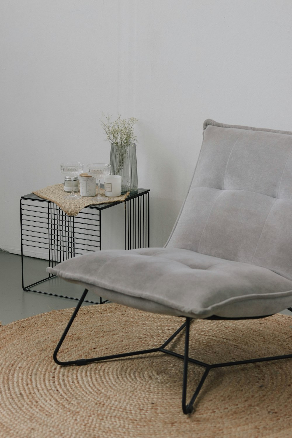 a chair sitting on top of a rug next to a table