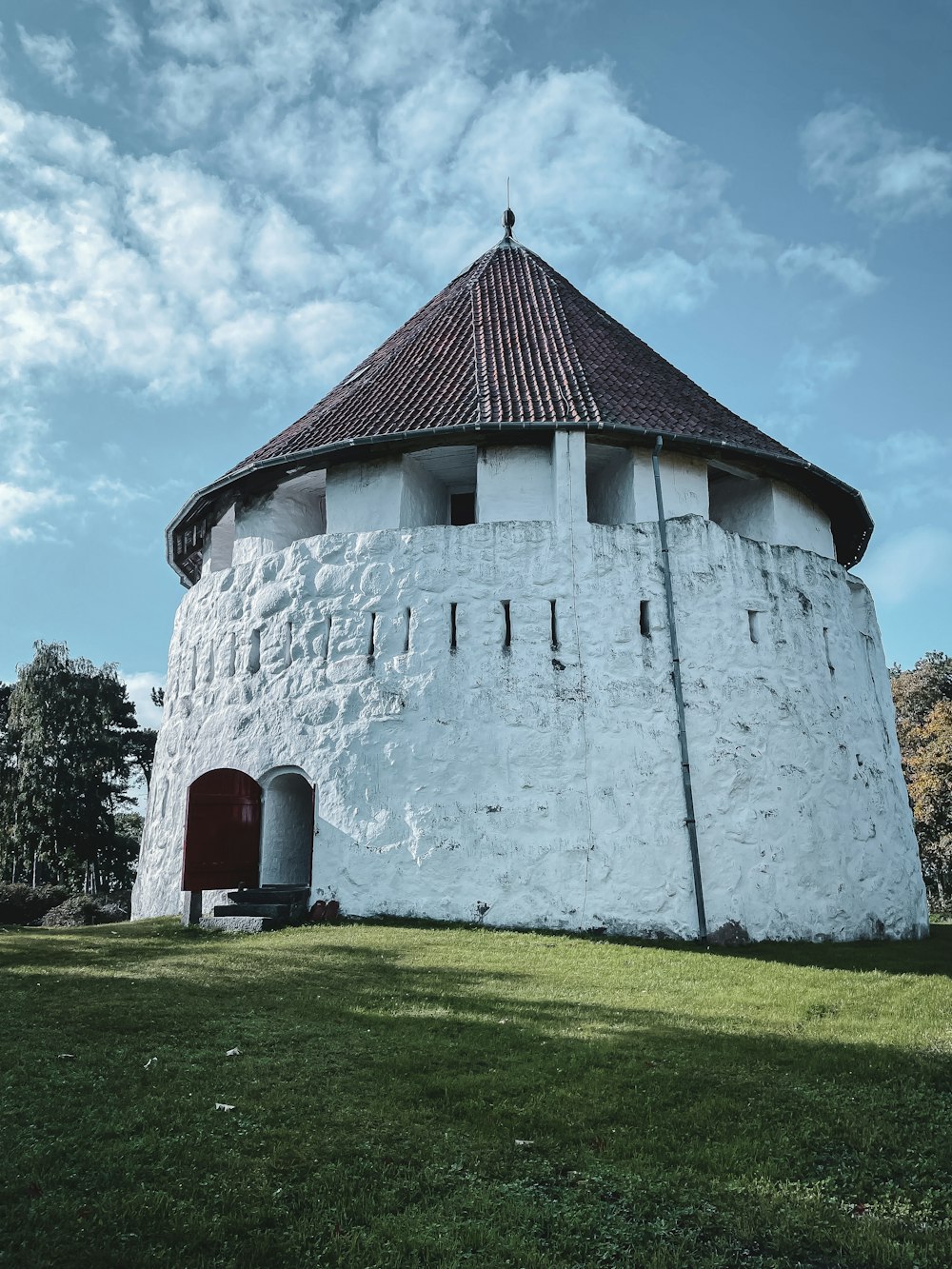 a large white tower with a brown roof
