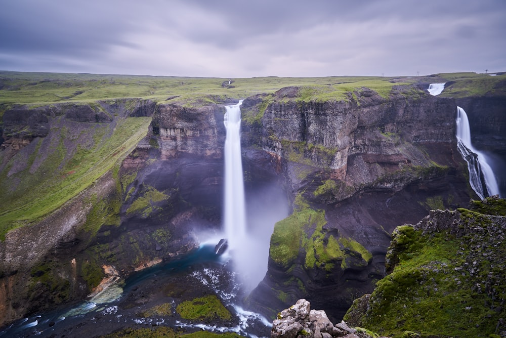 a waterfall with a waterfall in the middle of it