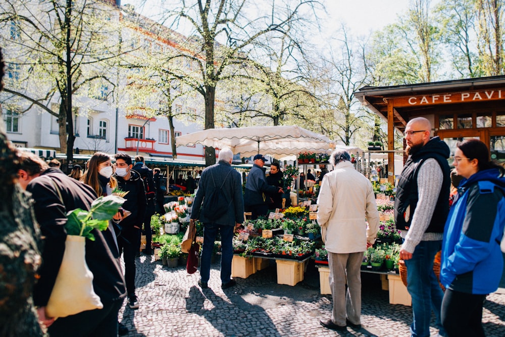 a group of people standing around a market