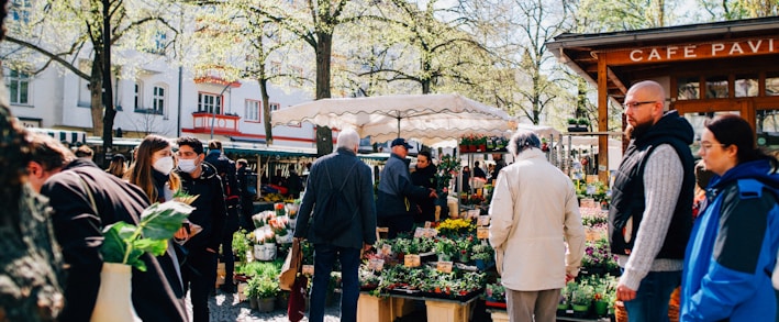 a group of people standing around a market