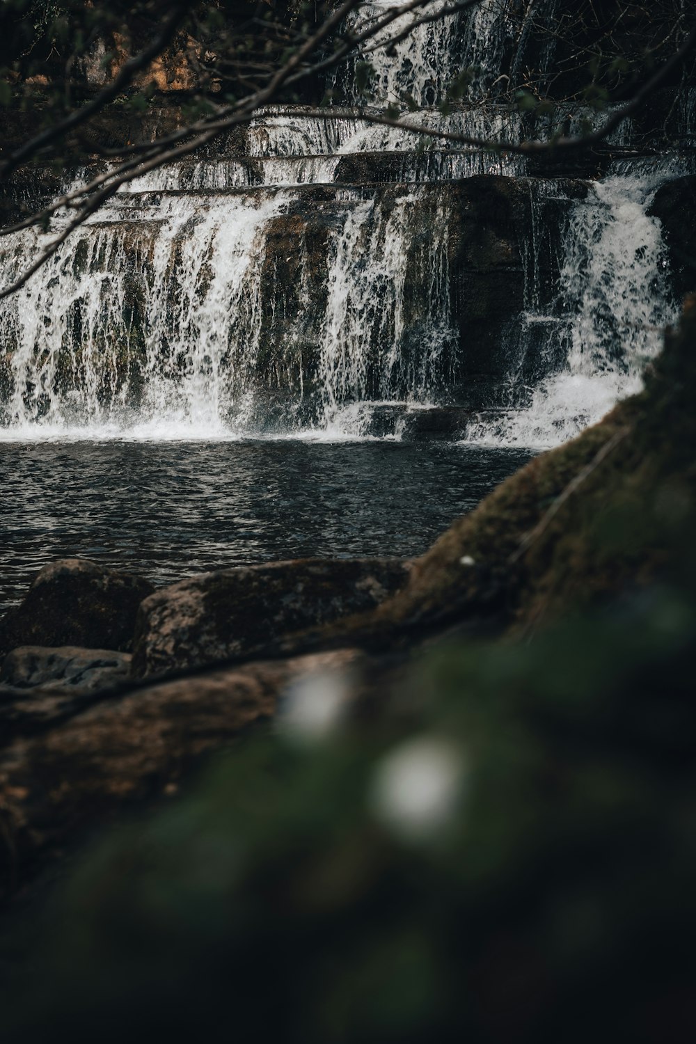 a waterfall with water cascading over it