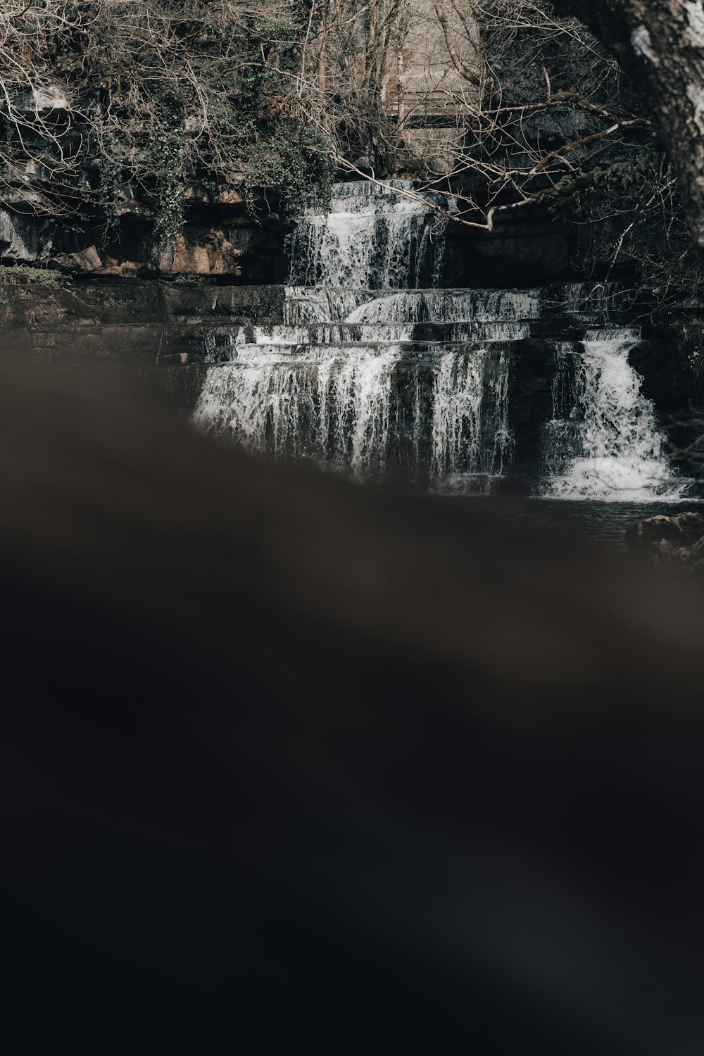 a waterfall is seen from the water below