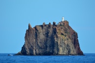 A rugged volcanic island with dramatic cliffs rising from the ocean.