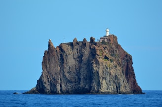 A rugged volcanic island with dramatic cliffs rising from the ocean.