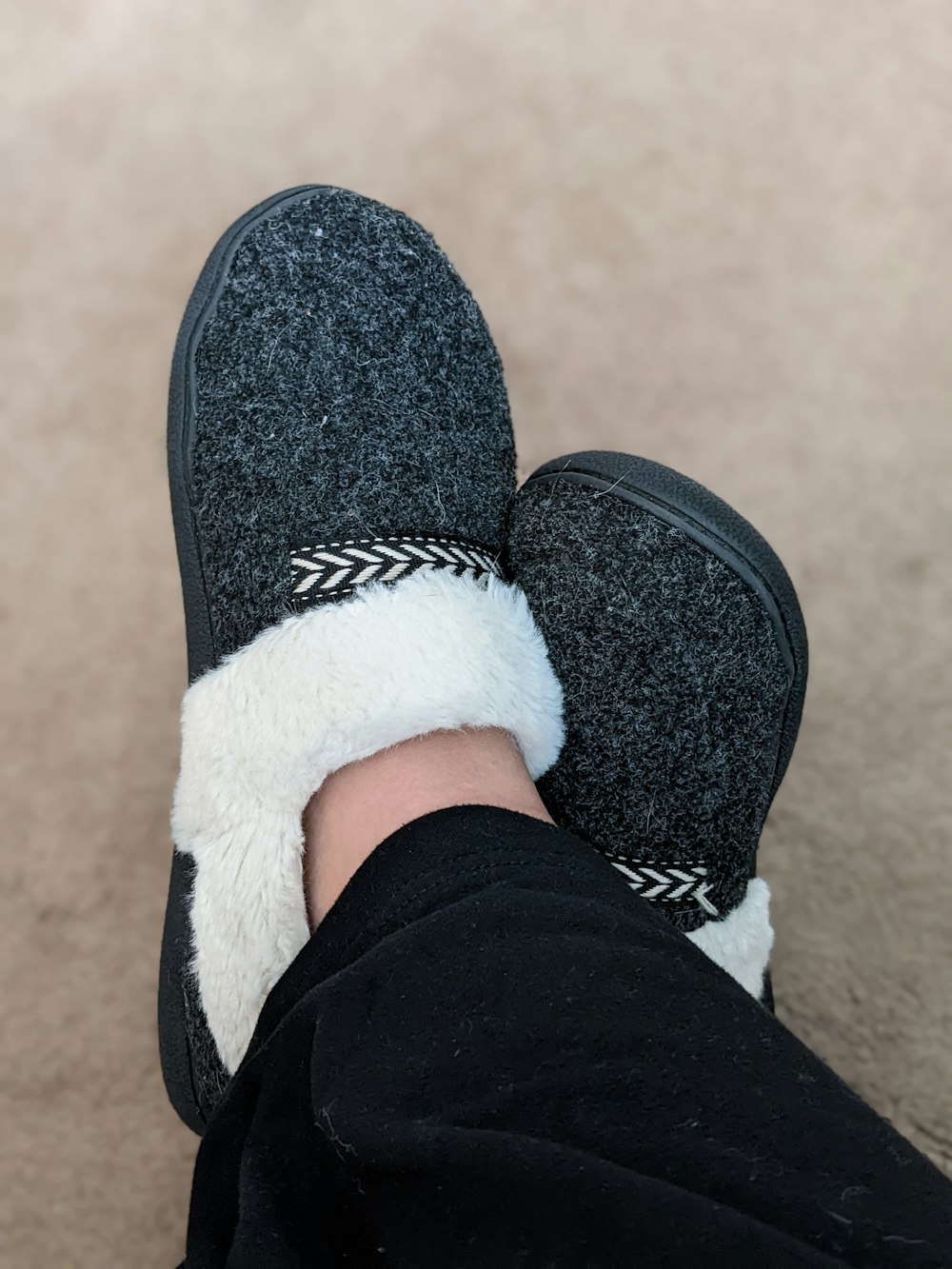 a person's feet with a pair of slippers on