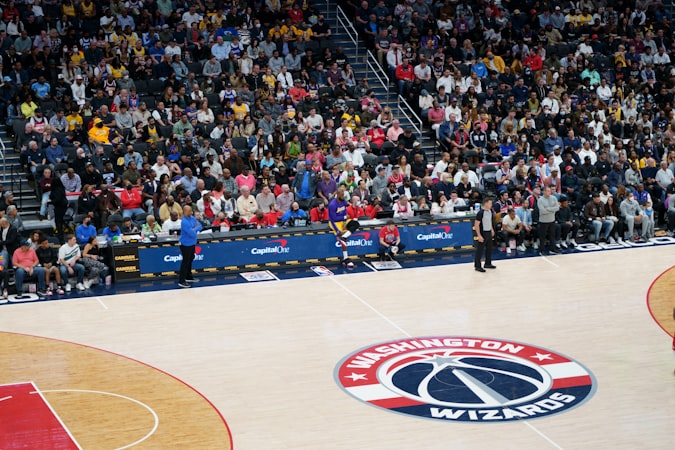 Enthusiastic crowd of fans watching a live basketball game from the stands
