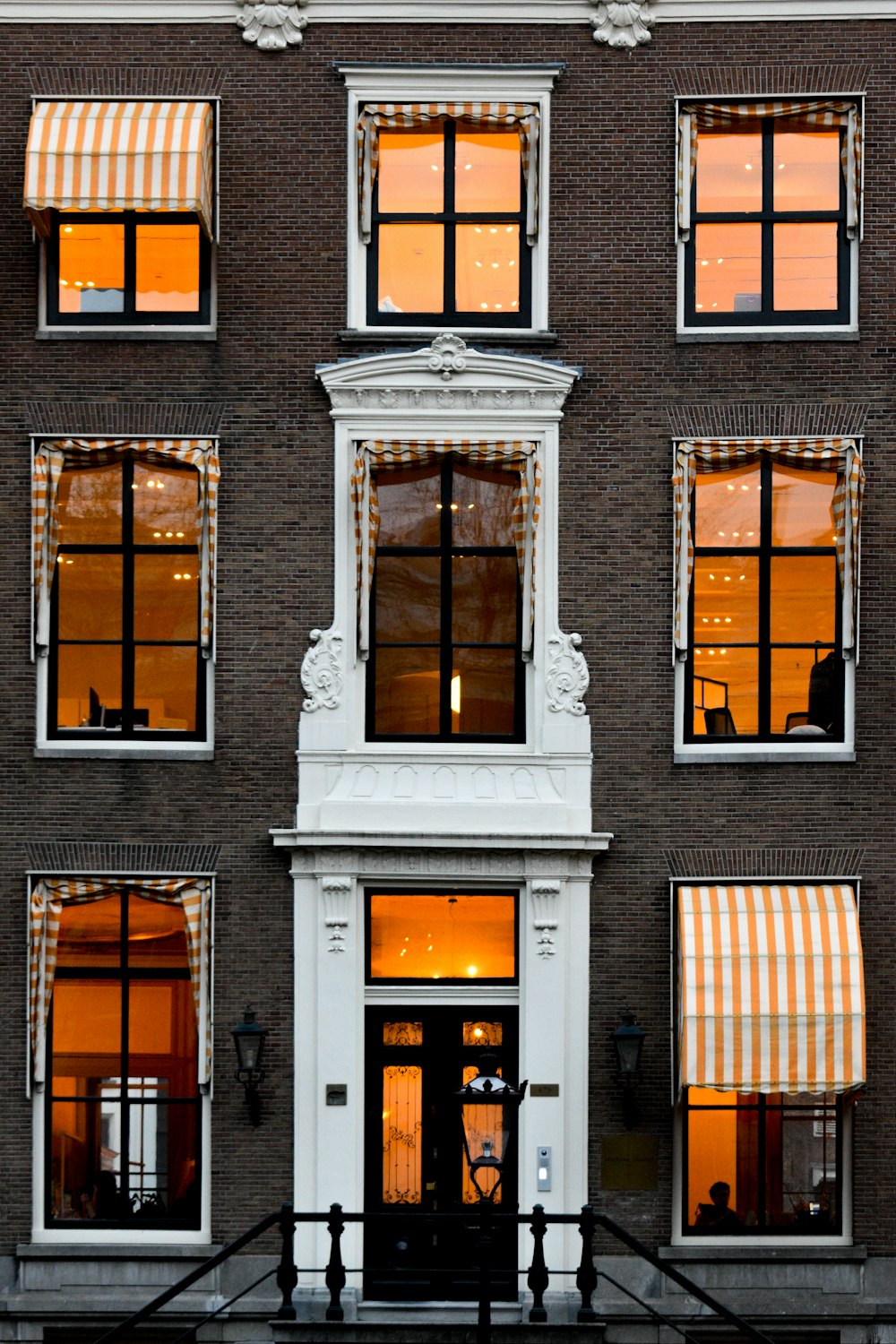 a tall building with many windows and awnings