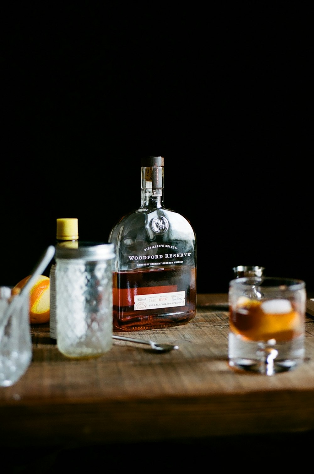 a bottle of liquor sitting on top of a wooden table