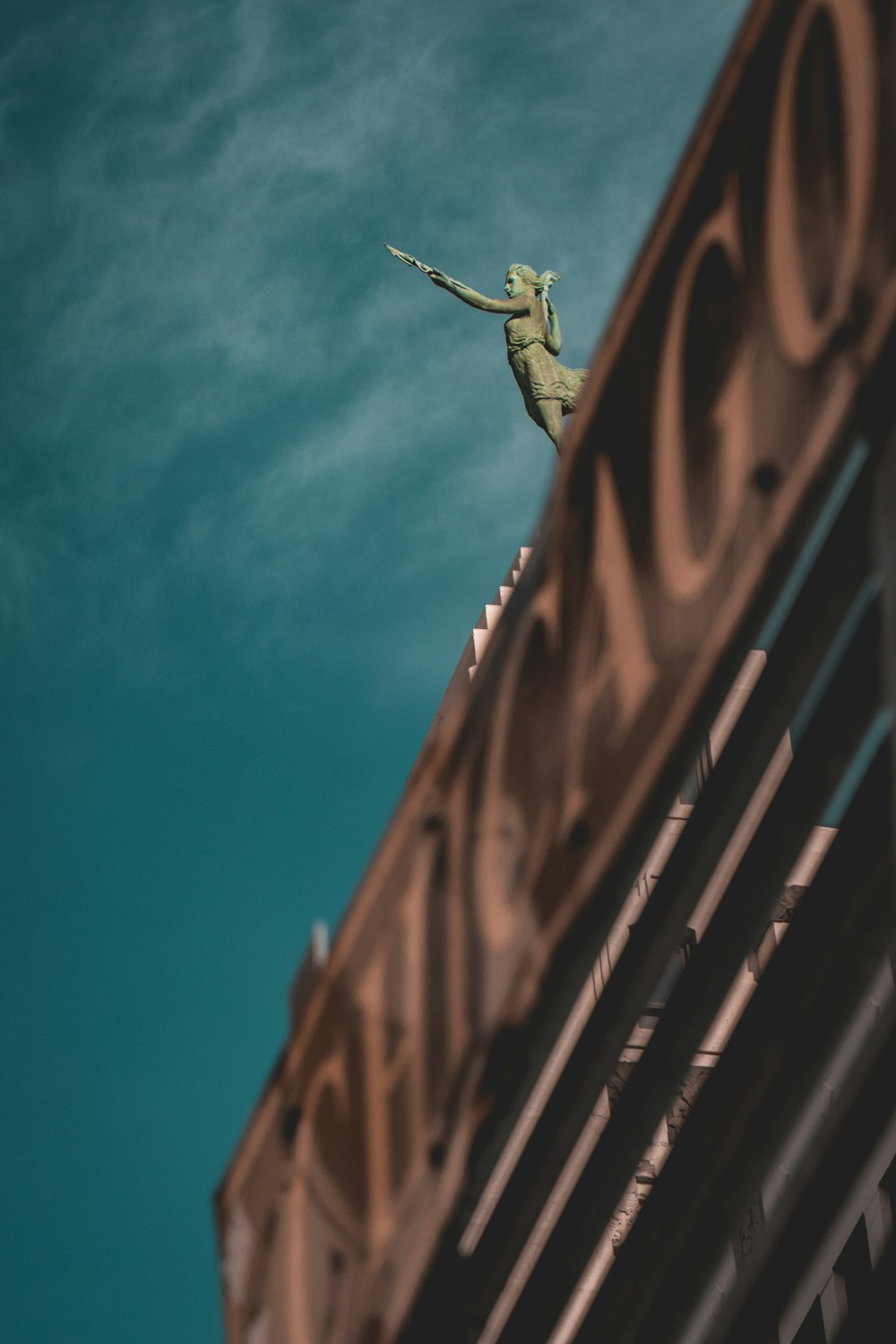 a statue of a woman on top of a building