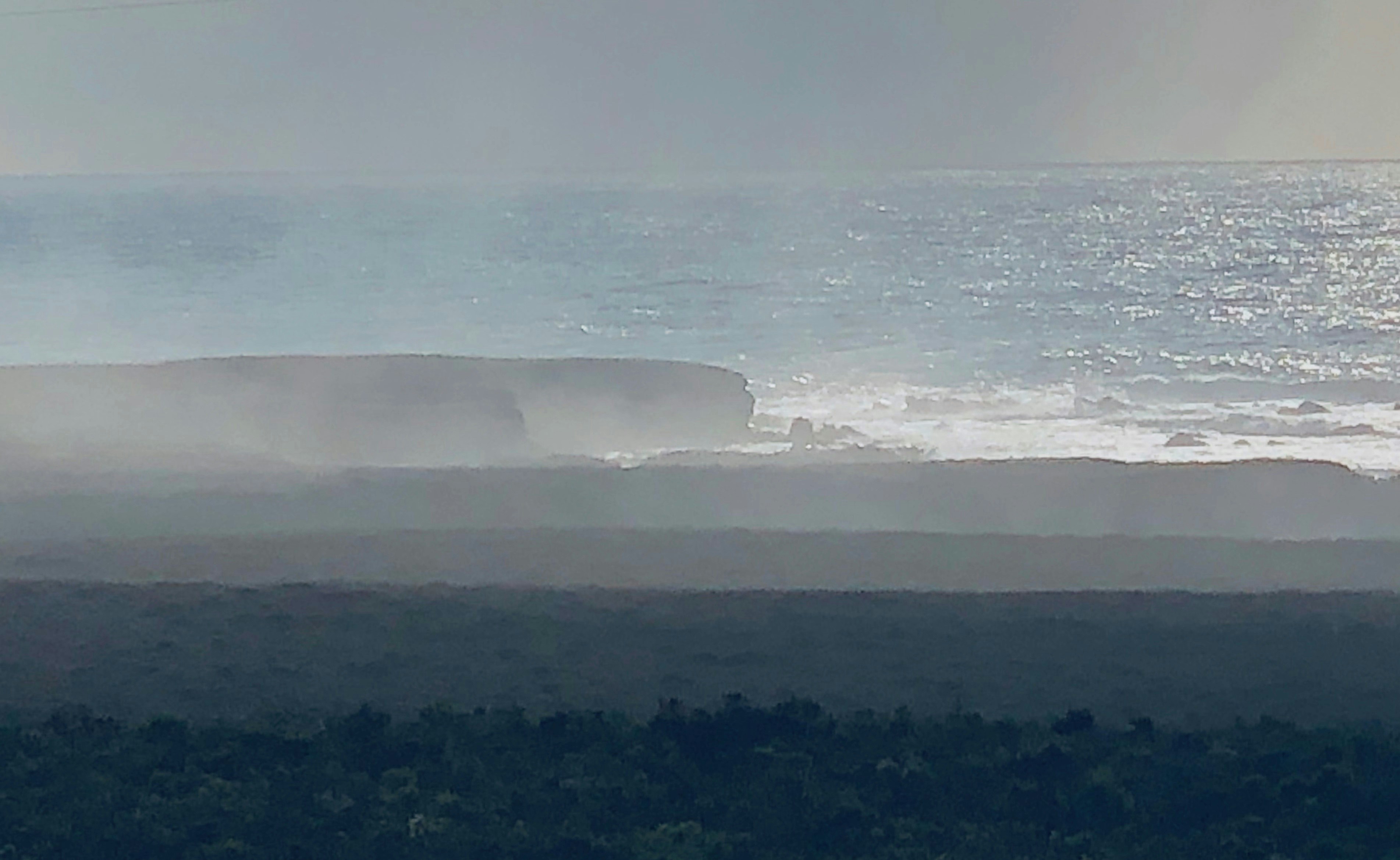 a person riding a surfboard on a wave in the ocean