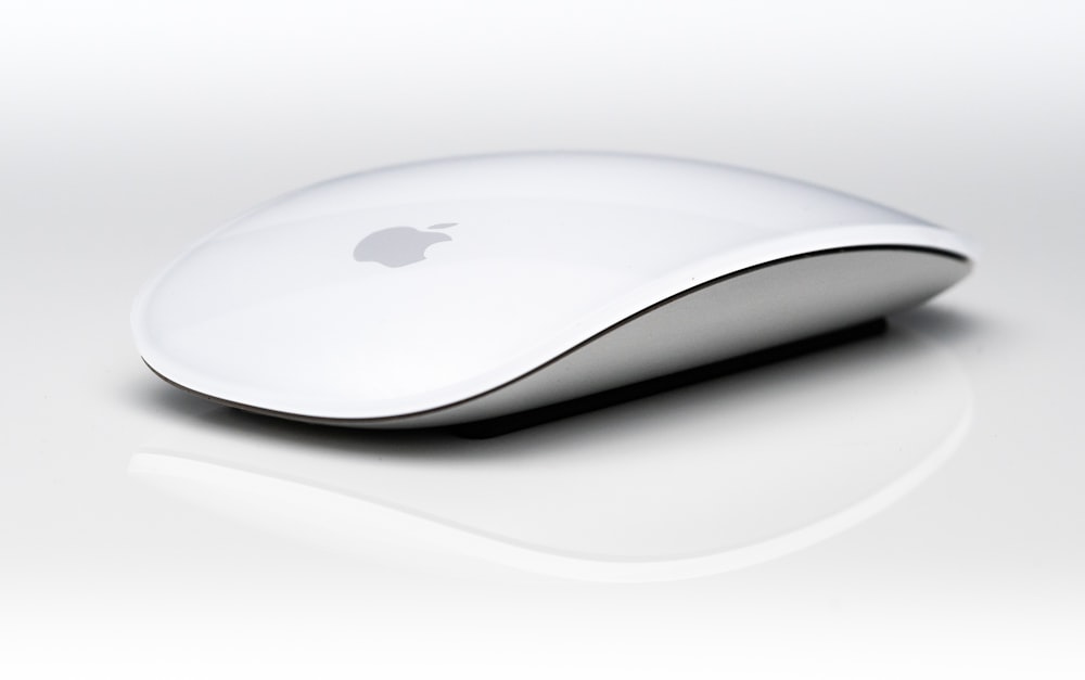 a computer mouse sitting on top of a white surface