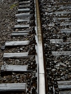 a close up of a train track with rocks and gravel