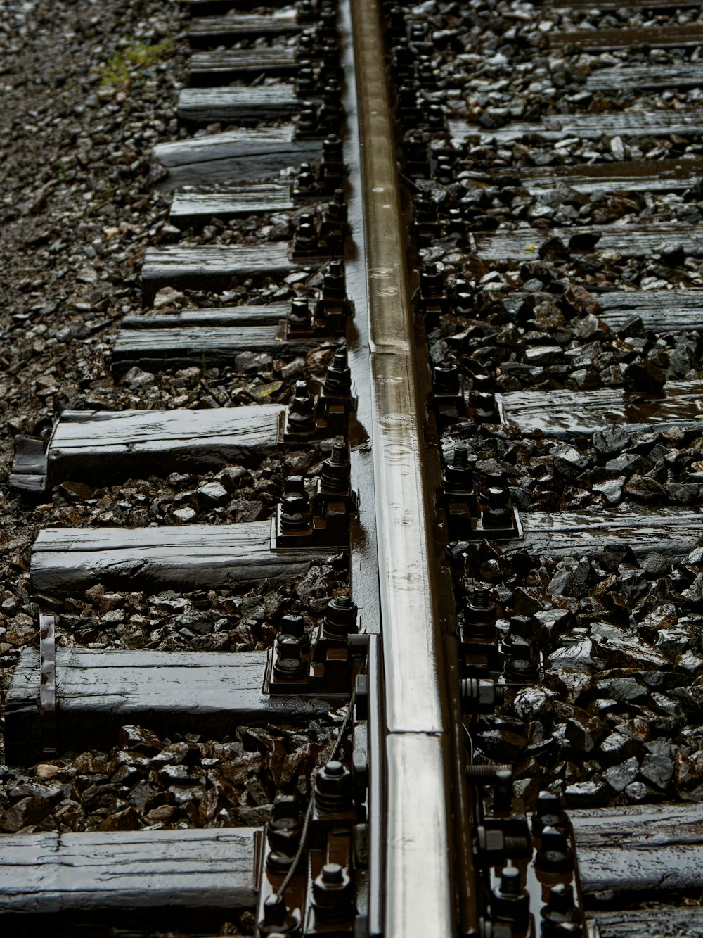 a close up of a train track with rocks and gravel