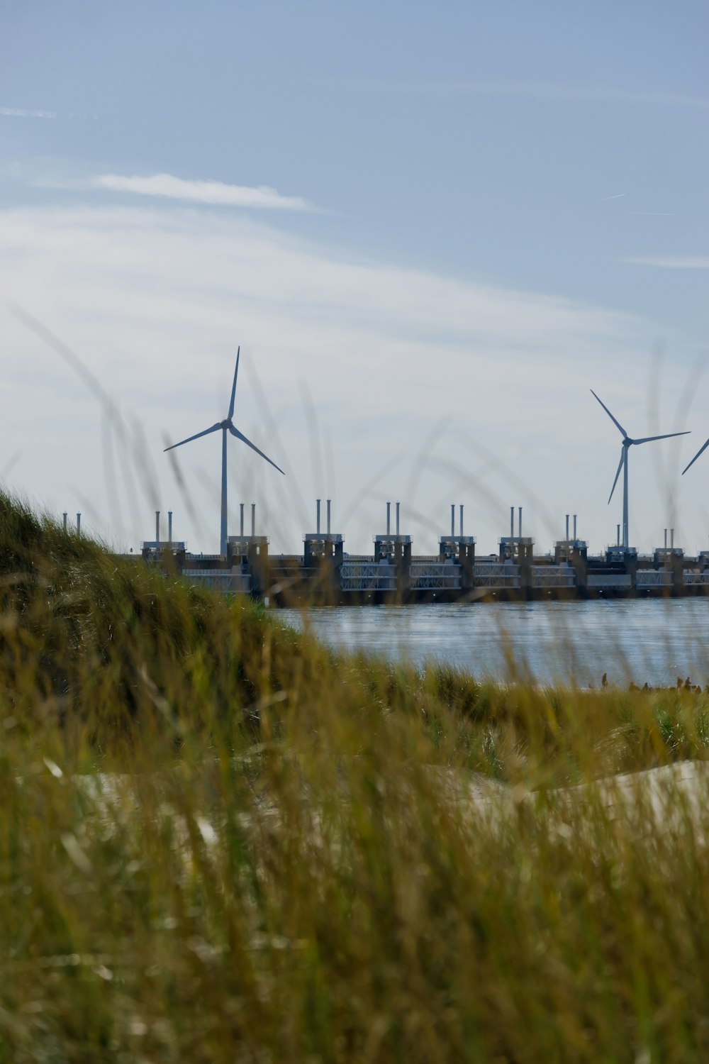 a wind farm with wind turbines in the background