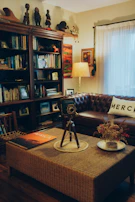 A cozy living room with warm lighting, a stack of classic DVDs, and a notebook filled with handwritten movie notes.