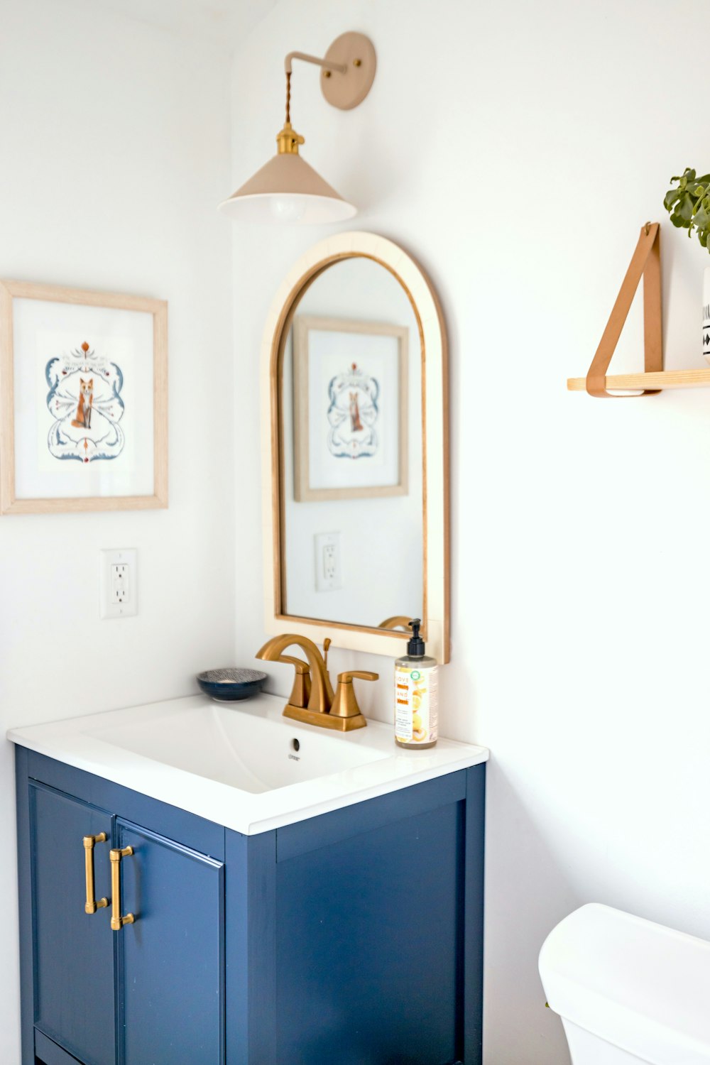 a bathroom with a sink, mirror and toilet