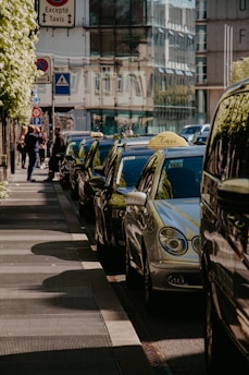 A clean, polished fleet of Star Cabs vehicles lined up ready for service under bright daylight.