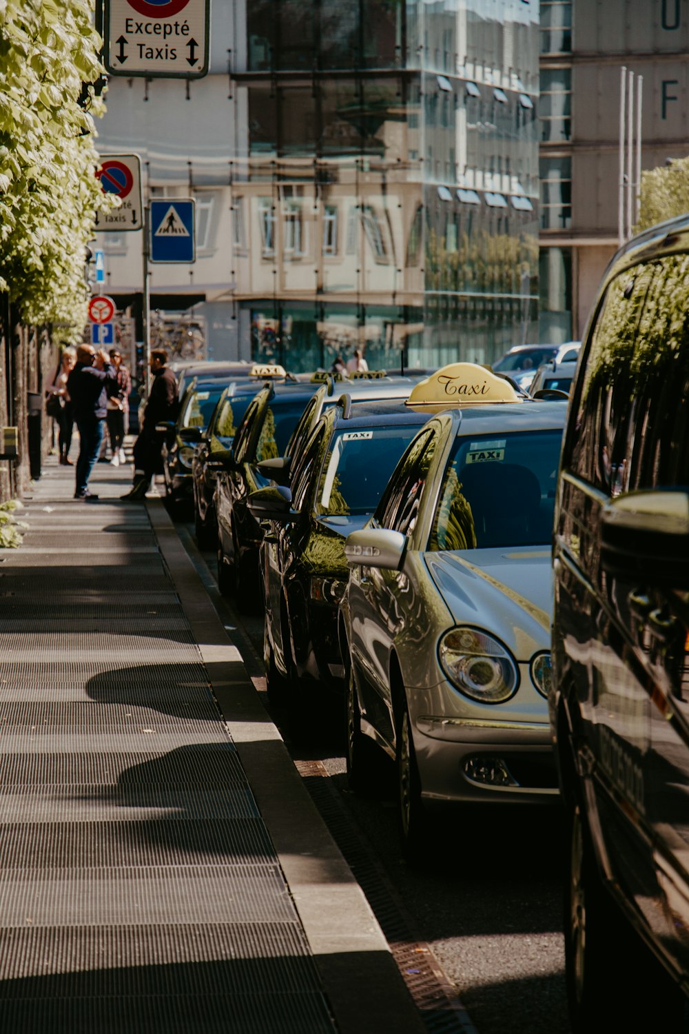 a row of parked cars on a city street