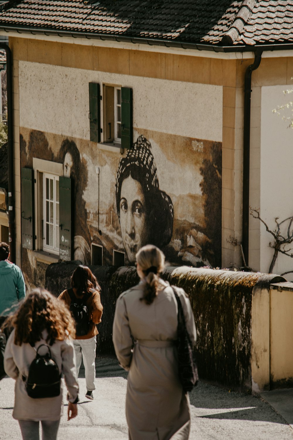 a group of people walking down a street next to a building