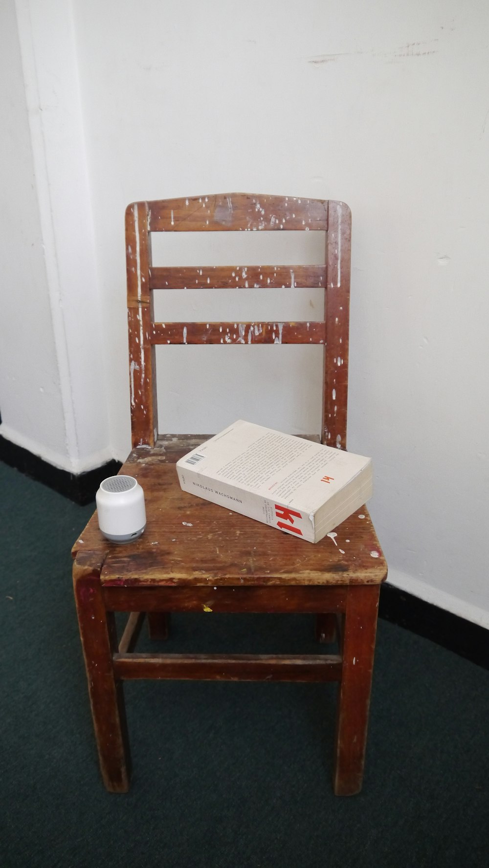 a wooden chair with a book on top of it