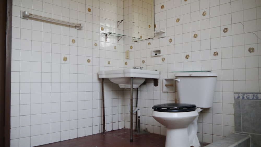 a white toilet sitting next to a white sink