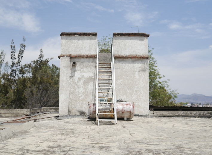 a ladder leaning against a building with a ladder