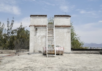 a ladder leaning against a building with a ladder