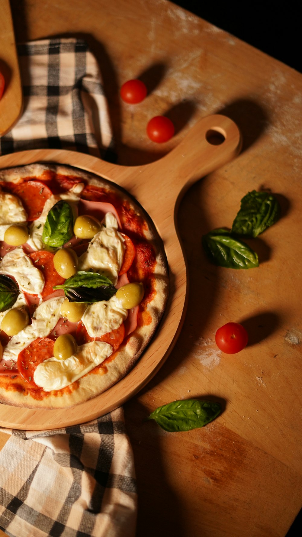 a pizza sitting on top of a wooden cutting board