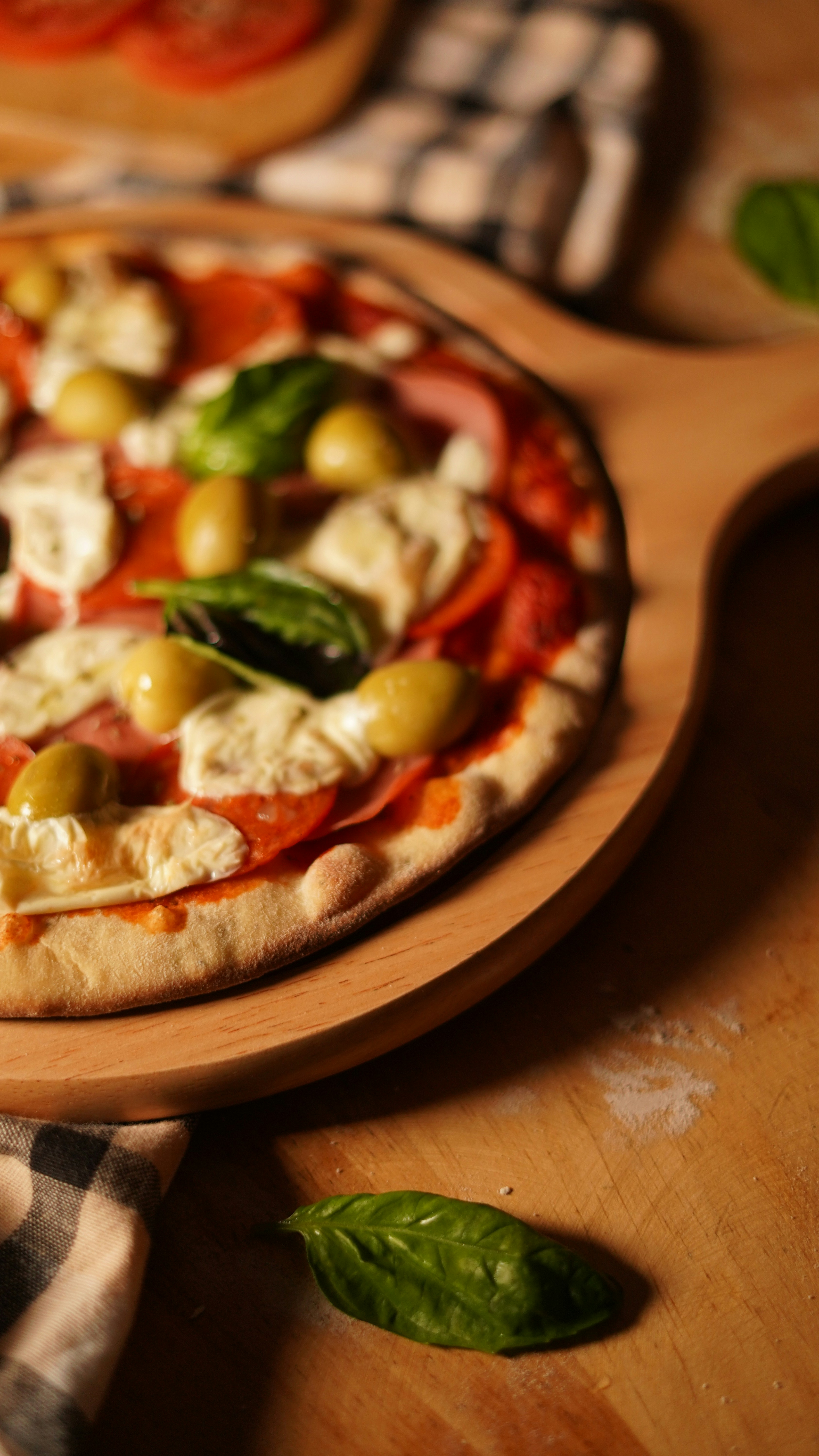 a pizza sitting on top of a wooden cutting board