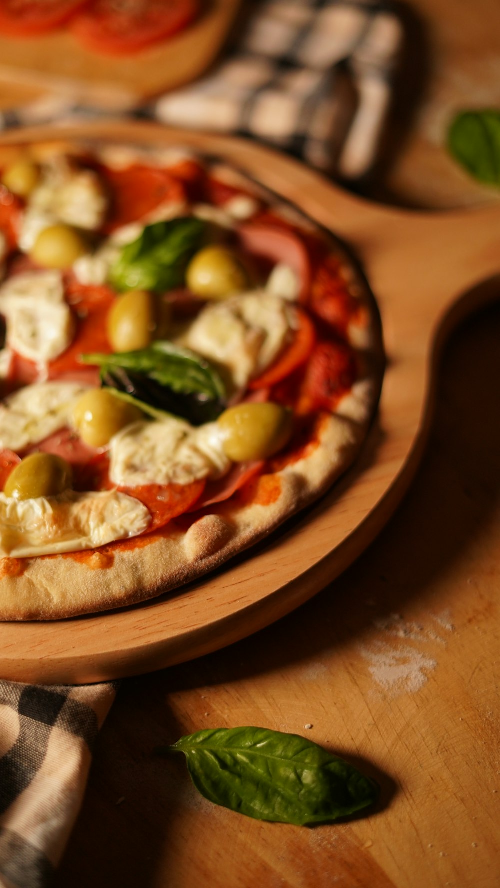 a pizza sitting on top of a wooden cutting board