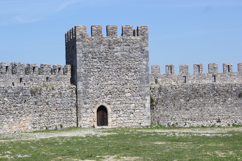 a stone castle with a door in the middle of it