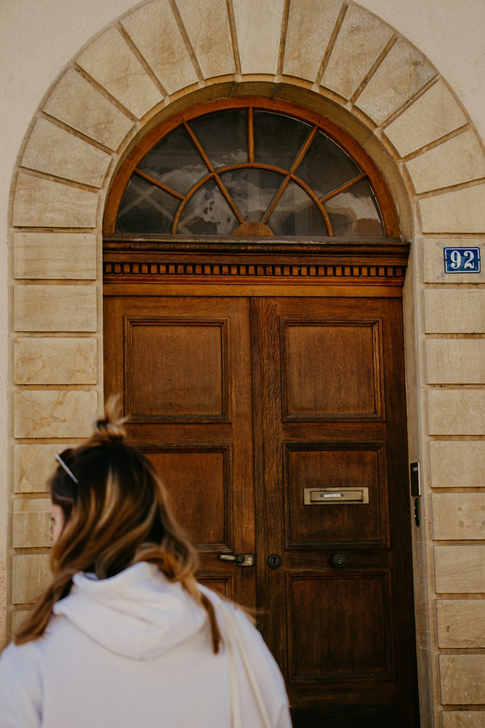 a woman standing in front of a wooden door