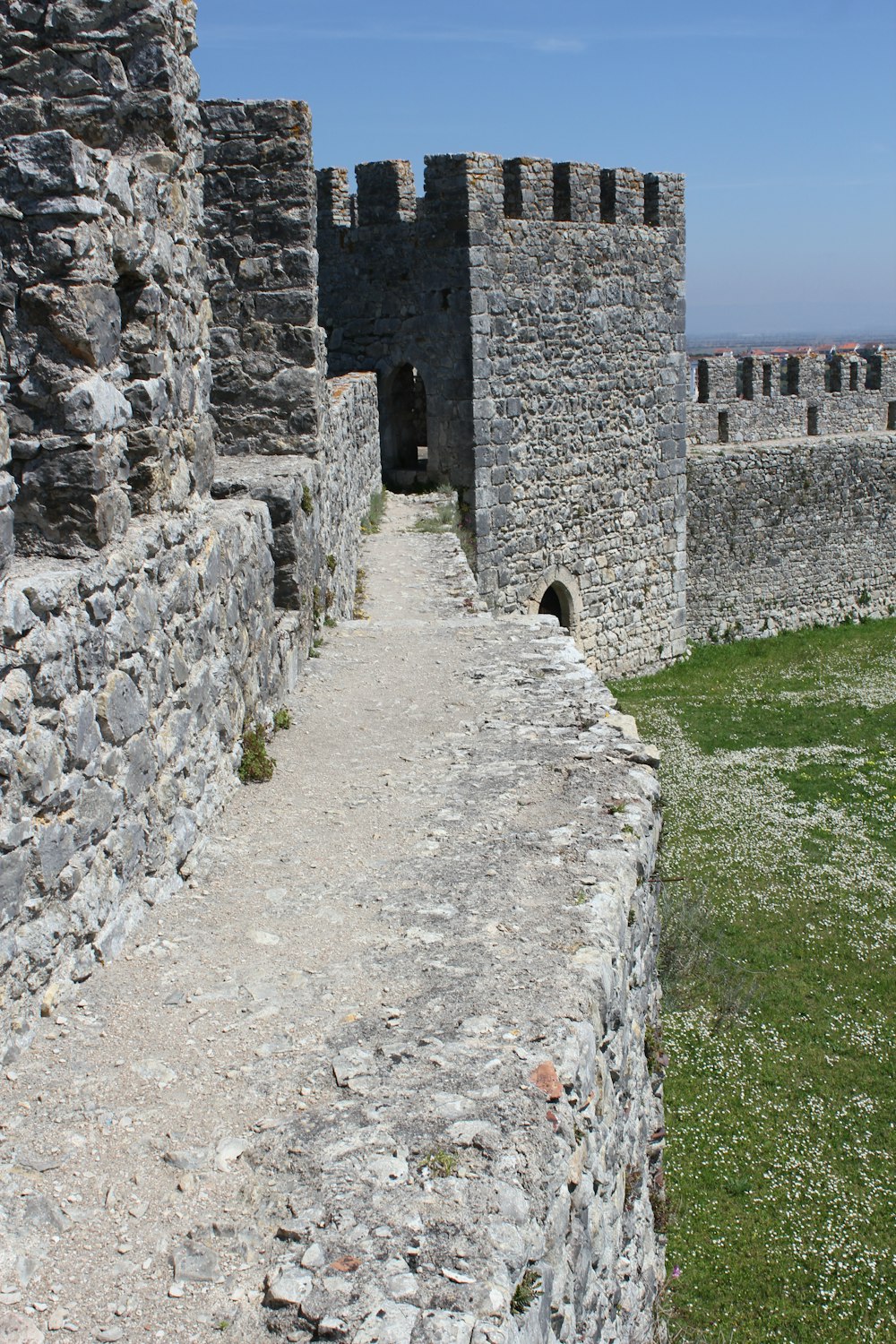 a stone path leading to a stone castle