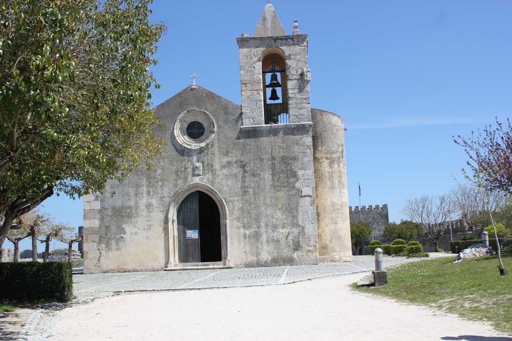 an old church with a bell tower on a sunny day