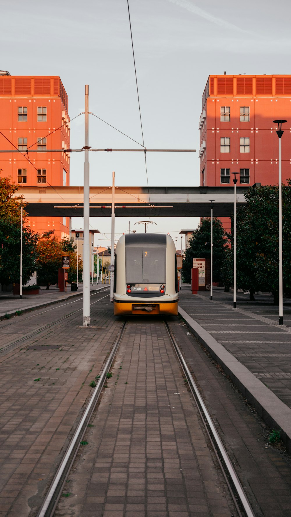 a train traveling down train tracks next to tall buildings