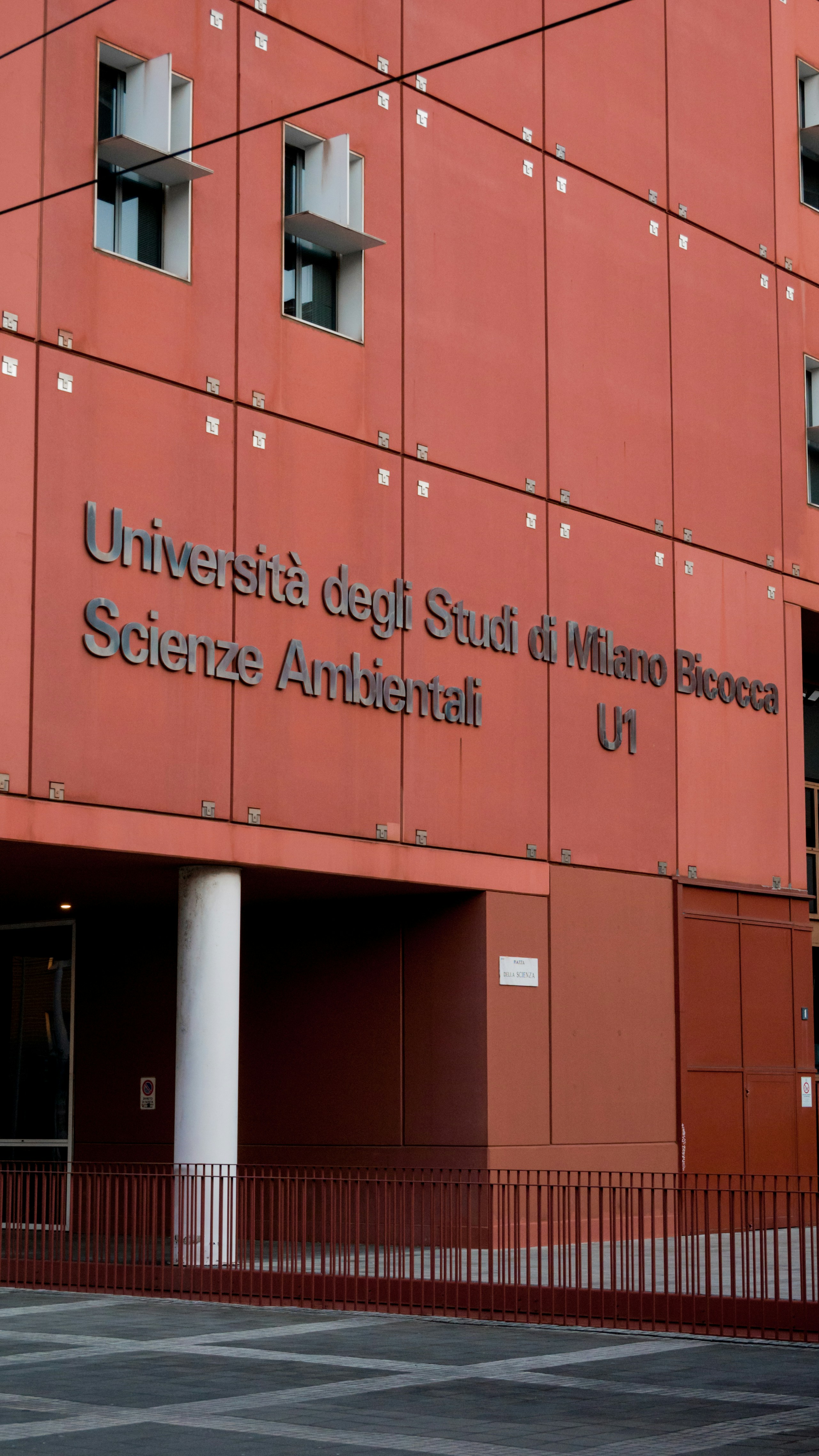 a red building with a sign on the side of it