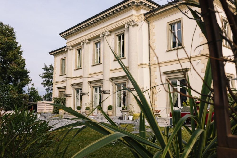 a large white building with a lawn in front of it