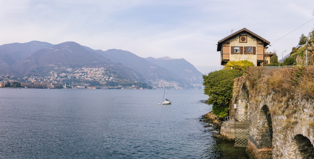 a house on the edge of a cliff overlooking a body of water