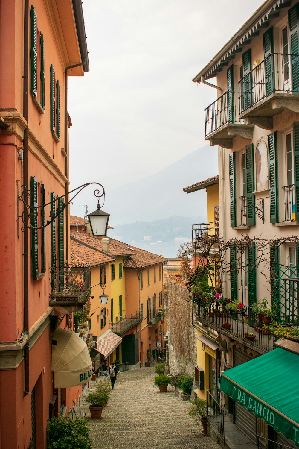 a cobblestone street lined with colorful buildings