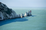 a group of white rocks sticking out of the ocean known as the Needles on the Isle Of Wight