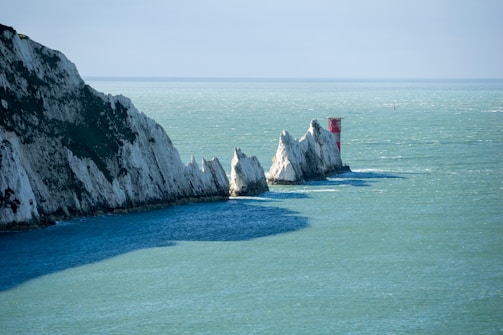 a group of white rocks sticking out of the ocean known as the Needles on the Isle Of Wight