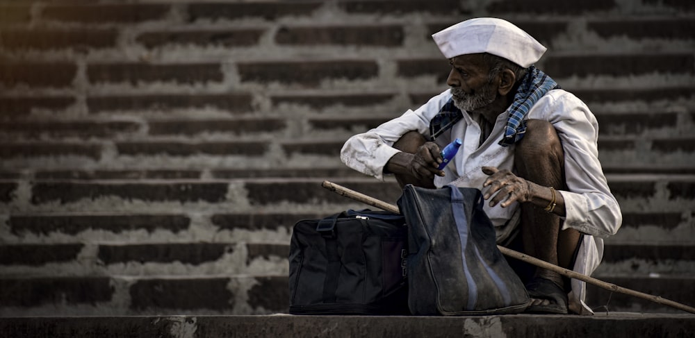 a man sitting on a bench holding a bag