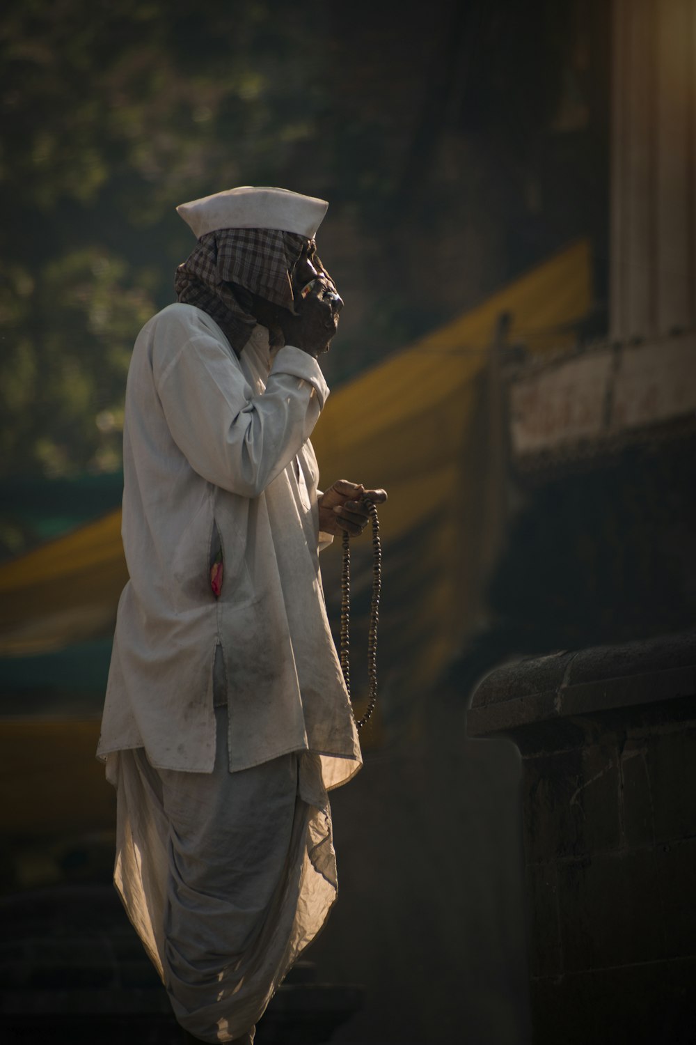 a person in a white outfit and a mask