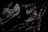 Crumpled and glossy black material with a texture resembling plastic or fabric. The surface displays various folds and creases, creating an abstract pattern.