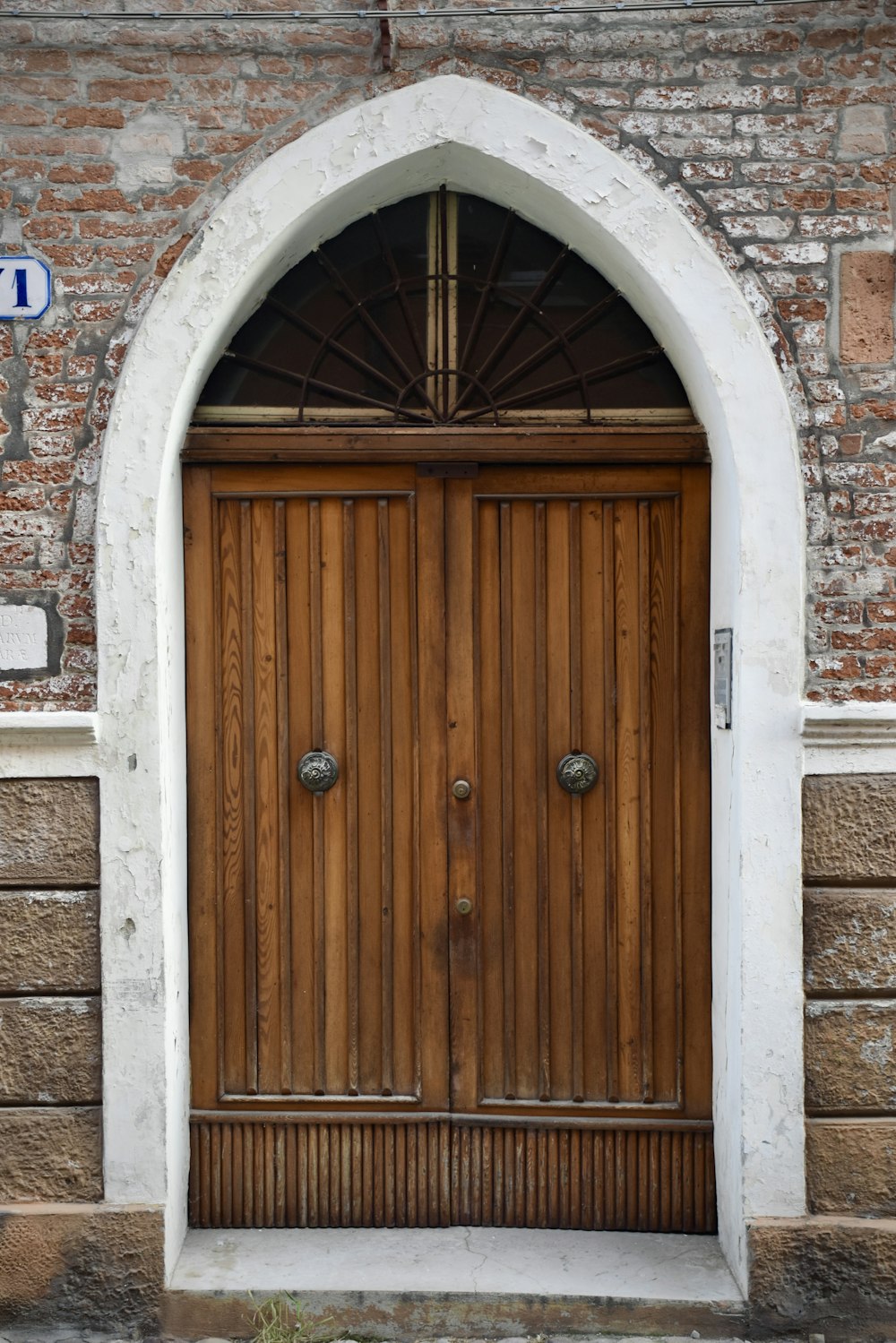 a large wooden door in a brick building