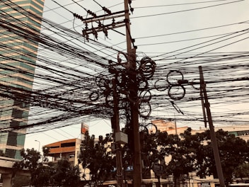 a bunch of power lines and wires in a city