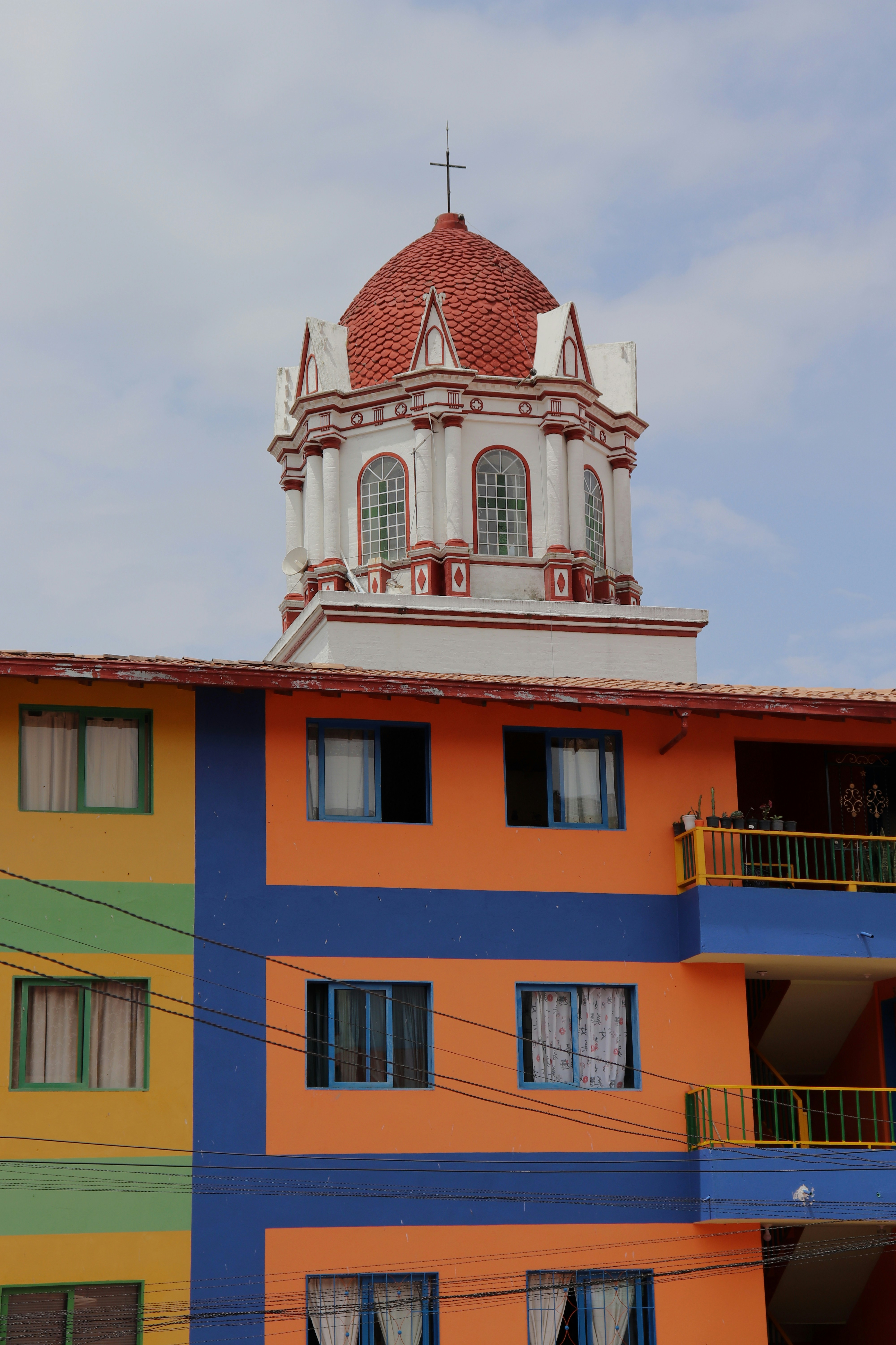 a multicolored building with a clock tower on top