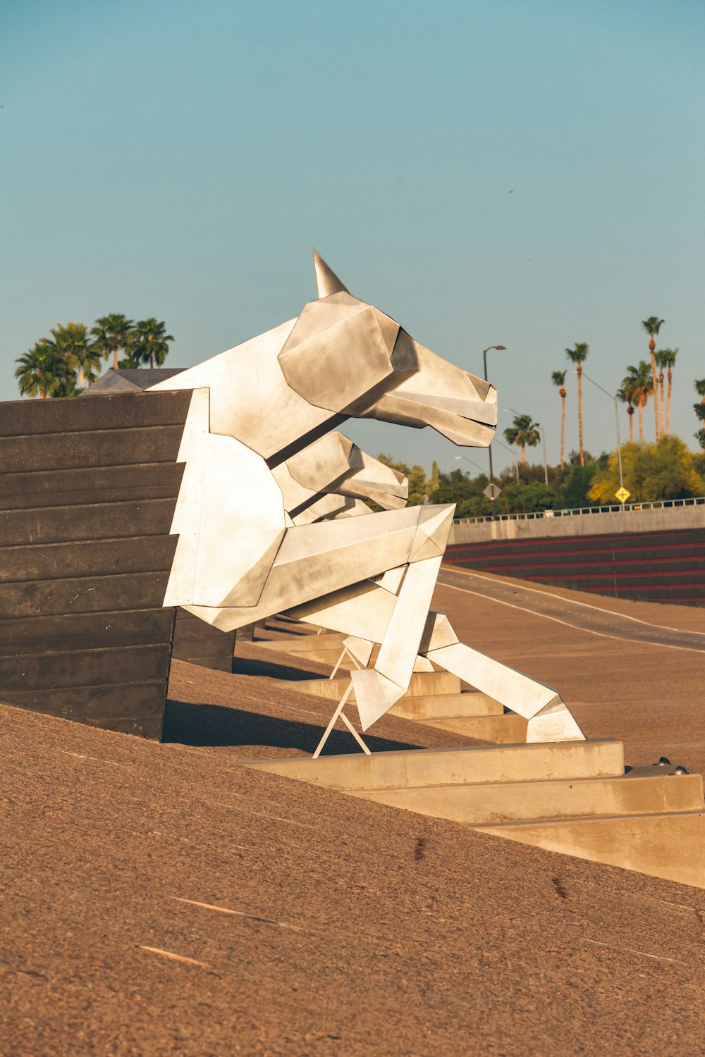 a sculpture of a dog on the side of a road