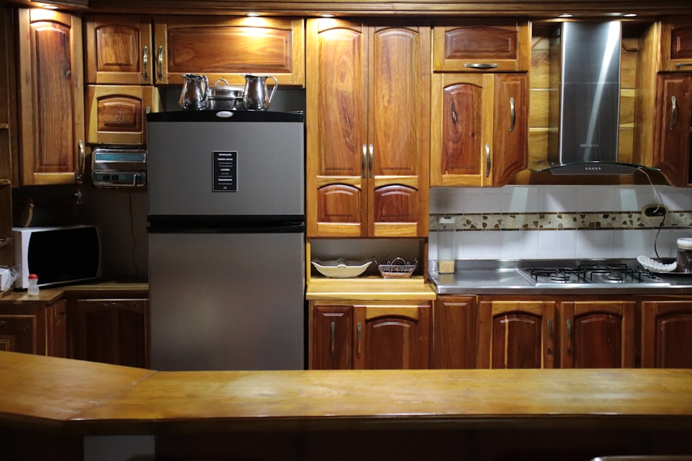 a kitchen with wooden cabinets and a metallic refrigerator
